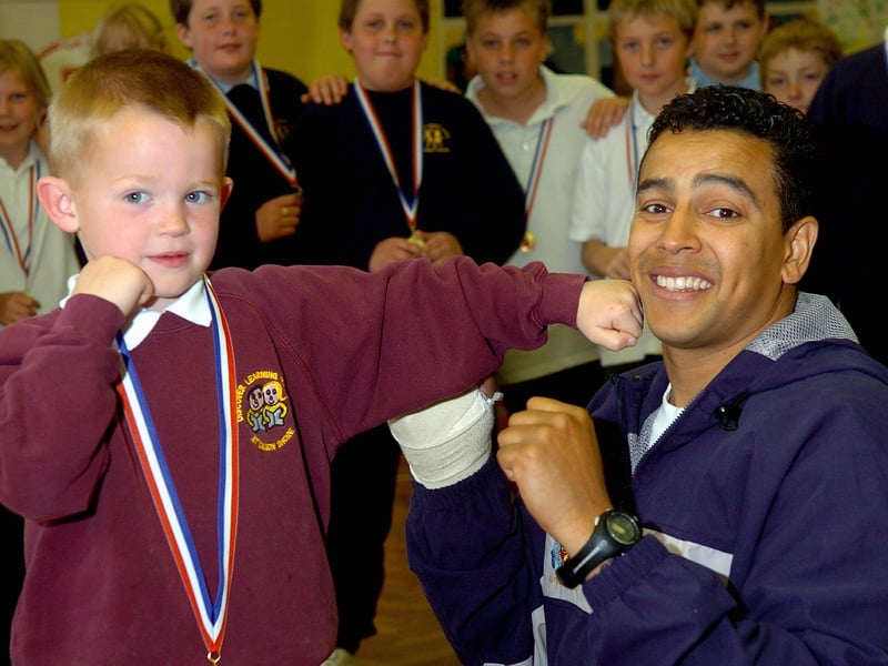 Navy boxing coach 'Q' Shillingford takes one on the chin from 5-year-old Paulsgrove Primary School pupil Jack Van der Lugt, the youngest of several children from the school to take part in a program promoting boxing in schools in 2006