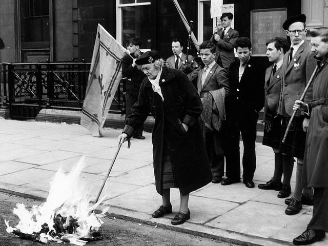 Dedicated Scottish Nationalist Wendy Wood burns a flag and leaflets to protest at the 'English' government outside the Australian Office in St Andrews Square.