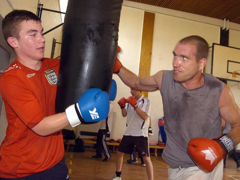 Curtis Conway holds the punch bag as Graham Kelly lands a punch at Fareham Boxing Club in 2007.