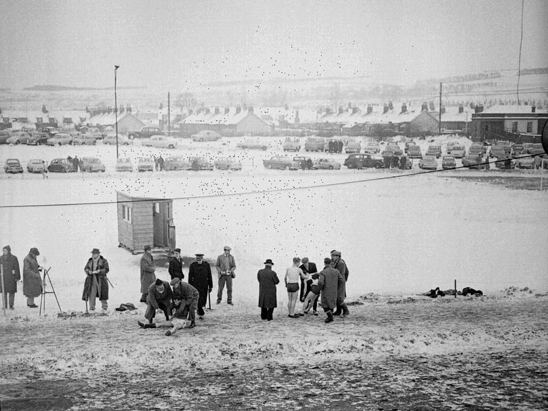Two runners are helped afer collapsing at the New Year Sprint at Newtongrange in 1959.