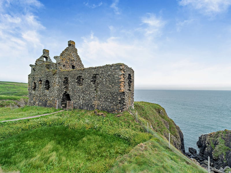 The castle is nestled within eight acres of land, with an expanse of grass in front of the castle and the cliff edge