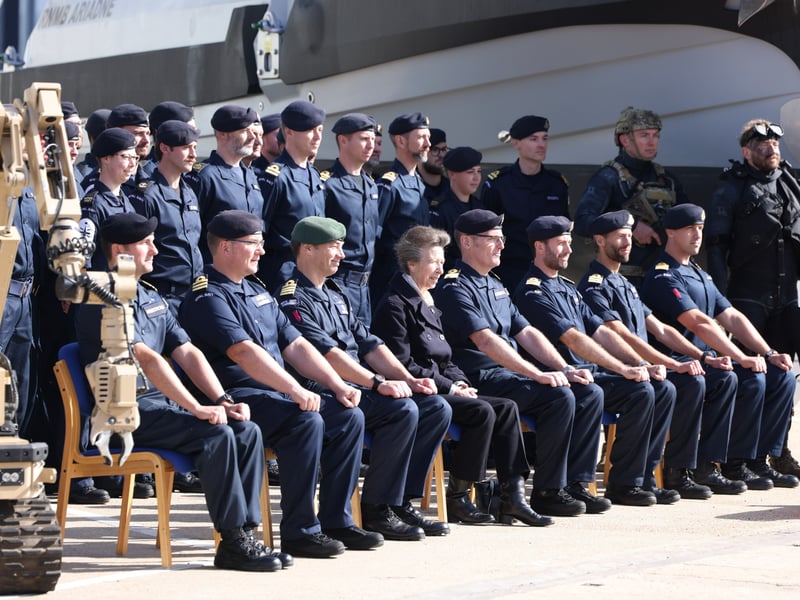 HRH The Princess Royal sat alongside the senior officers of PUXD in front of HMS Tyne