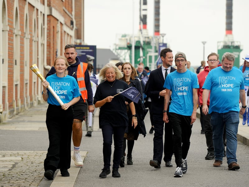 Pippa Bostock, sales and marketing director for The Mary Rose Trust carries the baton through Portsmouth Historic Dockyard.