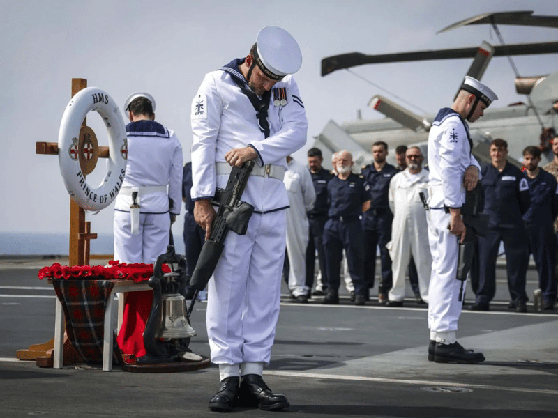 HMS Prince of Wales hosts a remembrance service and committal of wreaths over the site of the wrecks of the battleships HMS Prince of Wales and HMS Repulse. Japanese sailors supported their British counterparts with the commemoration.