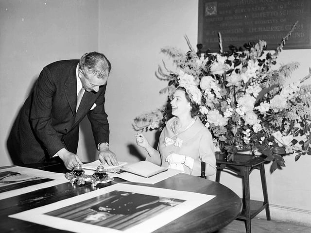 Queen Elizabeth II signs the visitors' book of  Loretto School on July 1, 1958. The Queen is pictured with headmaster Mr David Forbes Mackintosh.