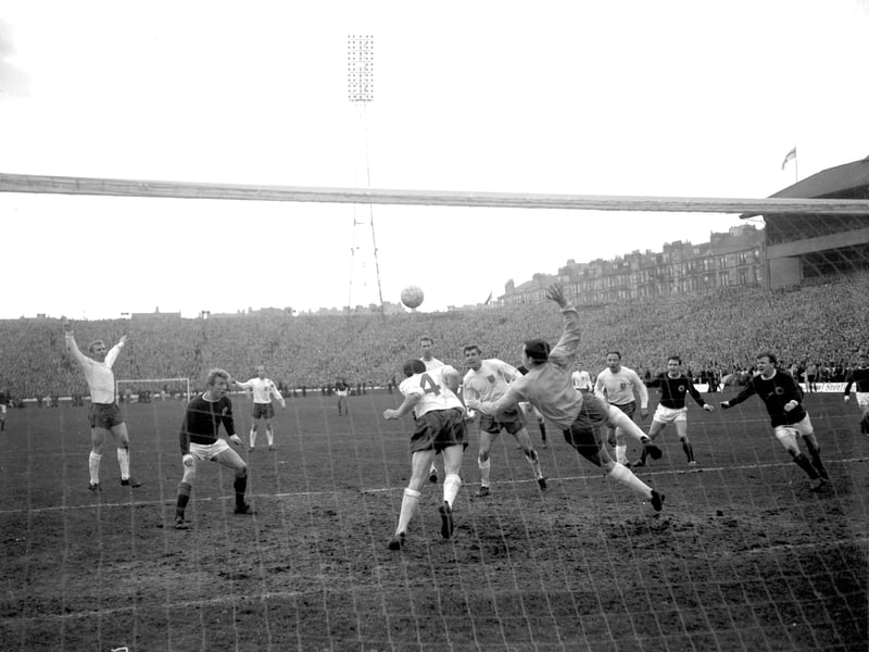 Scotland v England at Hampden April 1966. Nobby Stiles nods the ball away from the England goal at the last minute as Denis Law looks on in amazement.