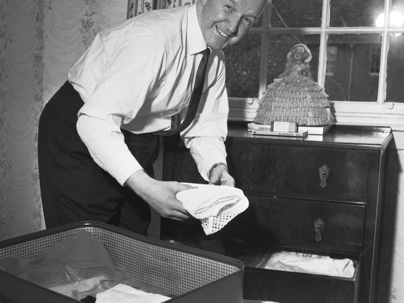 Scottish boxing referee George Smith packs his case to leave for the Cassius Clay - Henry Cooper fight in London, in May 1966.