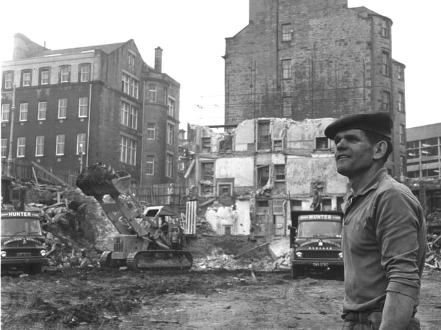 A bulldozer piles up waste as the demolition of St James Square in Edinburgh continues in August 1966.