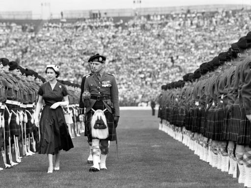 Queen Elizabeth II inspects guards from the Highland Light Infantry at Hampden Park.