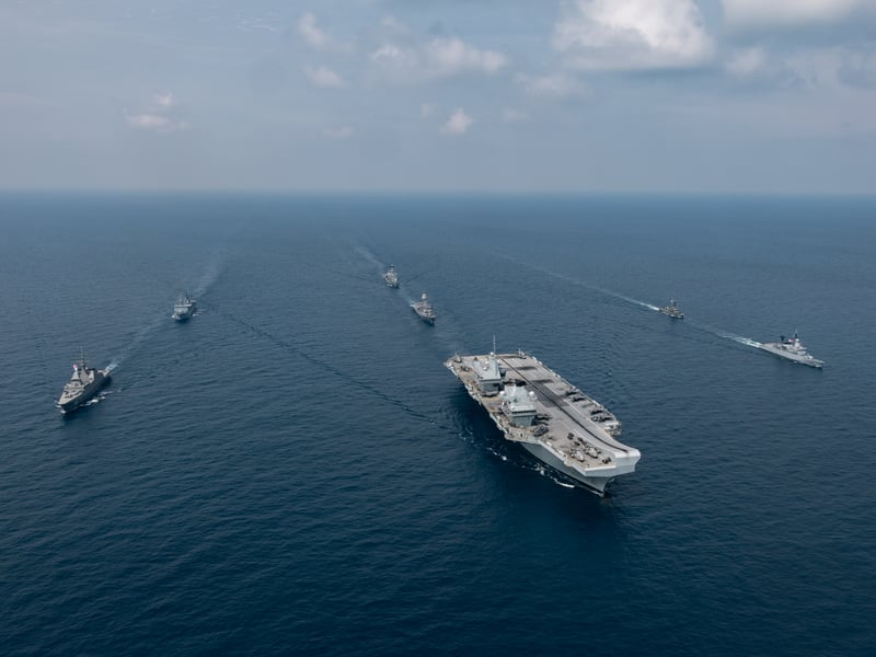 Aerial image of the Carrier Strike Group during Ex BERSAMA LIMA 2025 off the Malaysian coast, with HMS Prince of Wales at the helm.