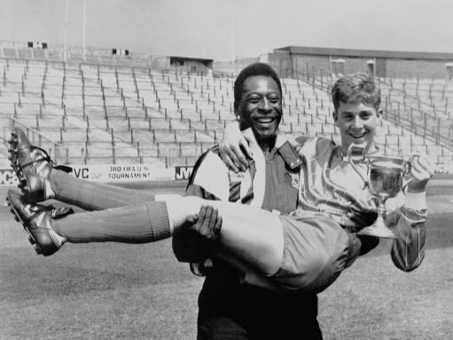 Legendary Brazilian footballer Pele giving his support to the Young Player of the Year, Graham Connell, of Victoria Drive School, at Hampden Park, Glasgow. Pele is in Scotland to help launch the Third FIFA World Under-16 Championship.