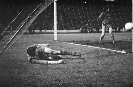 Ron Yeats of Liverpool rolls over in the net after kicking the ball out in disgust when Borussia Dortmund scored their winning goal by Reinhard Libuda in the European Cup Winners Cup Final at Hampden Park, Glasgow. Liverpool lost 2-1 after extra time.