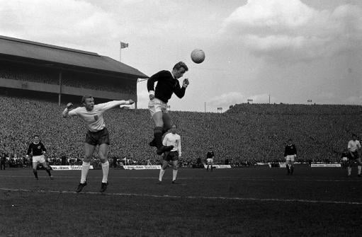 Denis Law beats England's Bobby Moore in the air to score Scotland's opening goal in 1966.