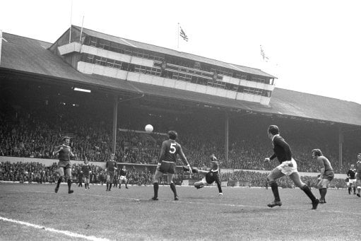 Denis Law scores Scotland's first goal in the 1971-72 British Home Championship match against Northern Ireland at Hampden, as Northern Ireland no. 5 Alan Hunter watches on. Scotland won 2-0.