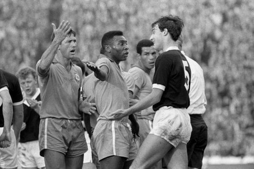 Brazil's Pele (c) remonstrates with Scotland's Ronnie MacKinnon (r) following a clash with Billy Bremner (left background).