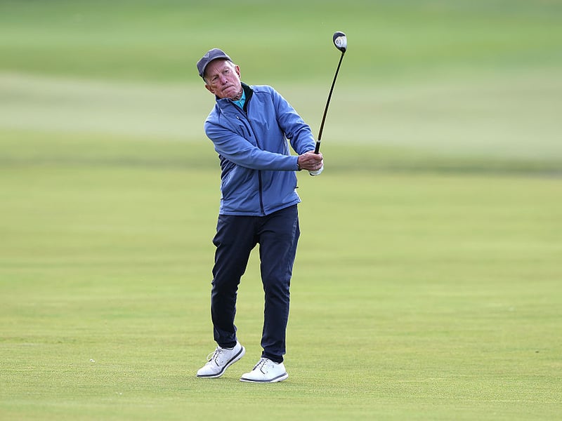 Billionare businessman and former New York Mayor Michael Bloomberg plays a fairway wood on the first hole of the Old Course.