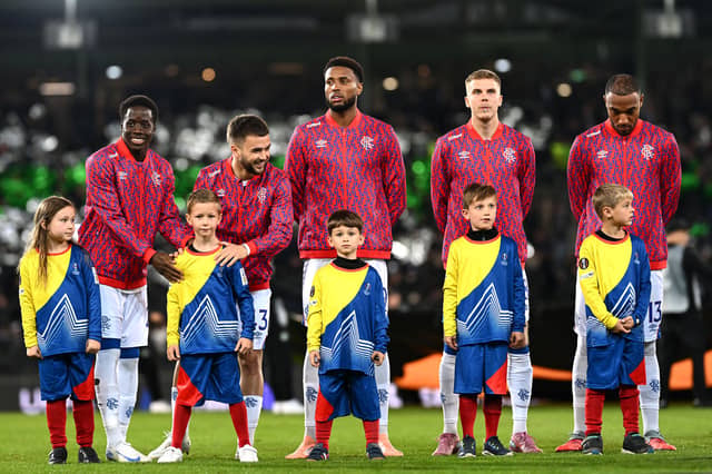 Rangers players interact with a mascot as the team lines up prior to the Europa League match against Sturm Graz at Woerthersee Stadion. (Photo by Christian Bruna/Getty Images)