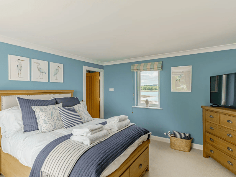The second floor is home to another double bedroom with a TV, serviced by a bathroom.