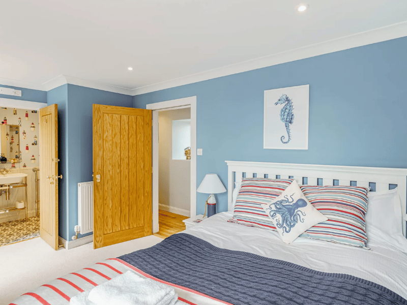 One room offers a pleasant double bed and an en-suite with a bath and shower over.