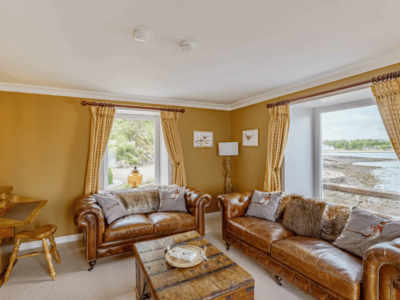 The additional sitting room where plush sofas invite you to "unwind in comfort".