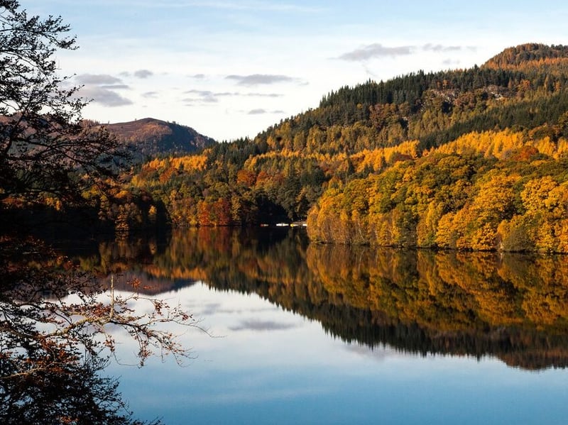 Often described as Pitlochry’s hidden woodland retreat, Black Spout Wood comes alive in autumn. This enchanting forest is a haven for walkers seeking quiet trails and nature-lovers hoping to glimpse red squirrels or roe deer among the trees.
The highlight of the walk is the spectacular Black Spout Waterfall, where the Edradour Burn plunges nearly 60 metres into a dramatic gorge. Hidden among the woodland, you’ll also find the remains of an Iron Age homestead, which has now softened by moss and time.
Explorers looking to indulge in some luxury after their walk can retreat to Fonab Castle Hotel & Spa, positioned in the heart of Pitlochry.
Complete with cosy furnishings and places to coorie in with a book in front of the fire, the five-star hotel is also home to the triple AA-Rosette award winning restaurant Sandemans, which welcomes guests for a seven-course tasting menu with matching wines that celebrate Scotland’s rich, autumnal larder.