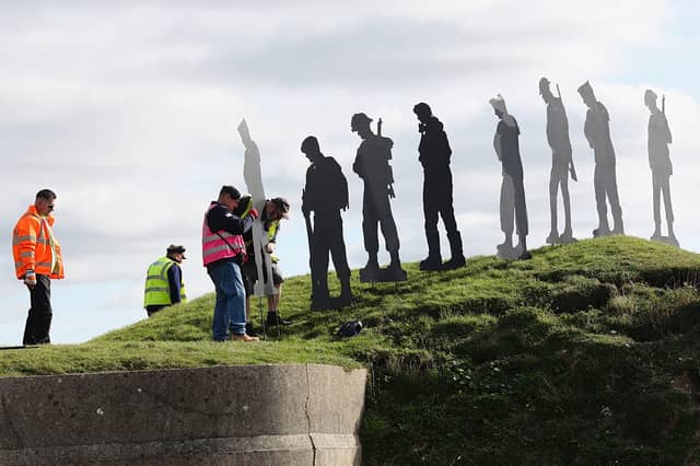 Volunteers installing the tribute at Fort Nelson