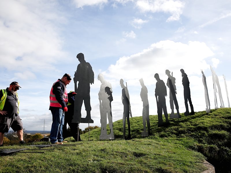 Volunteers install the tribute at Fort Nelson