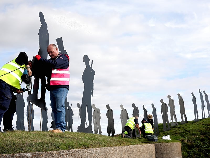 Volunteers install the tribute at Fort Nelson
