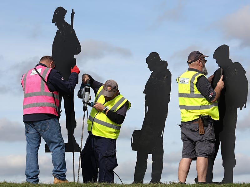 Volunteers install the tribute at Fort Nelson