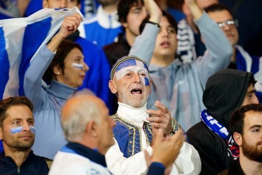 A Greece fan with his face painted gets behind his team in Mount Florida.