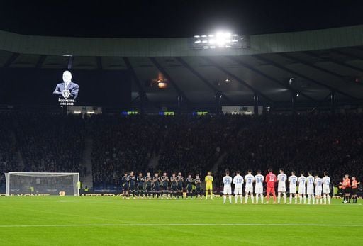Players and fans stand for a minutes applause in memory of Rod Petrie.