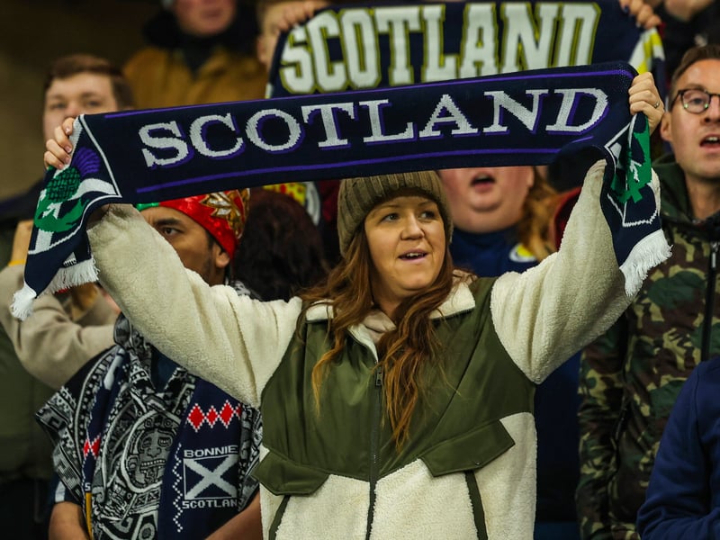 Former Glasgow City striker Suzanne Lappin holds a Scotland scarf above her head following Ryan Christie's equaliser.
