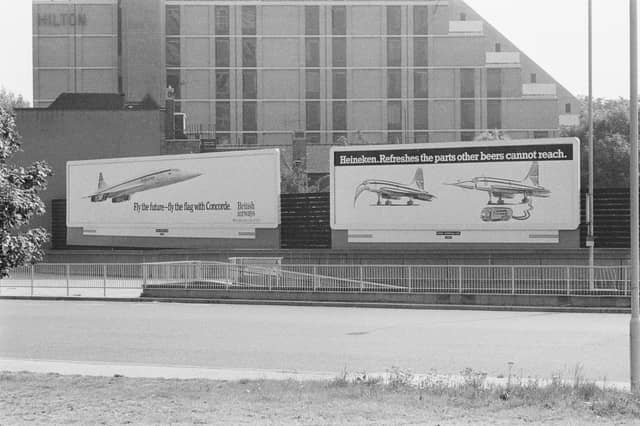 A billboard advertising Concorde and another beside it promoting Heineken beer, using the famous supersonic plane, in May 1976