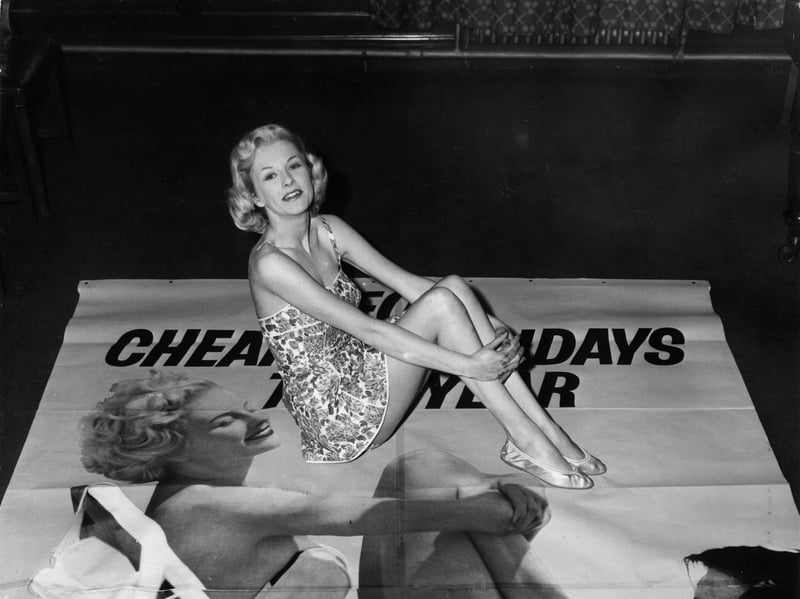 Stewardess Yvonne Bond with one of the posters advertising BEA (British European Airways)