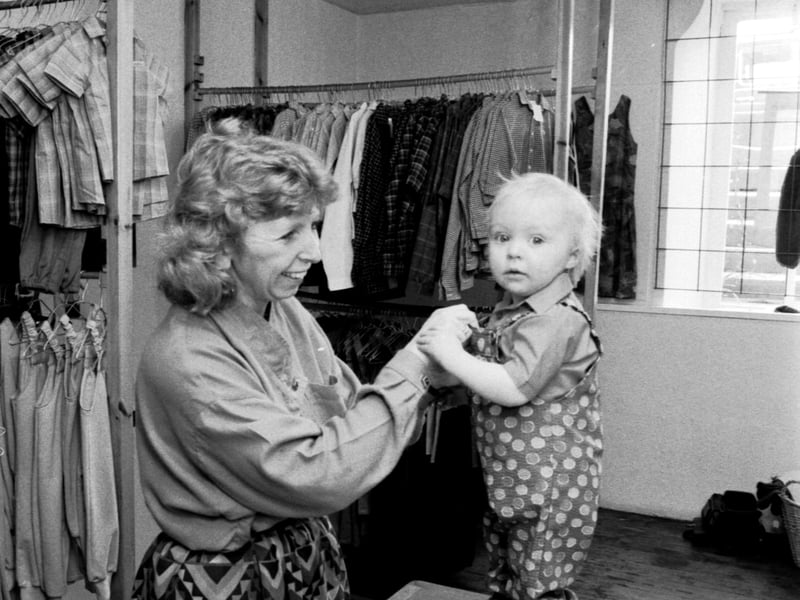 Co-owner Brenda Wingate with a satisfied customer at Baggins, makers of children's clothes in Stockbridge, Edinburgh, in April 1987