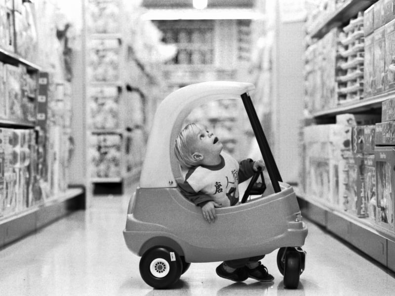 Two-year-old Kieran Casey in his pedal car, amazed at all the toys on sale at the Toys R Us superstore in Edinburgh, in September 1989