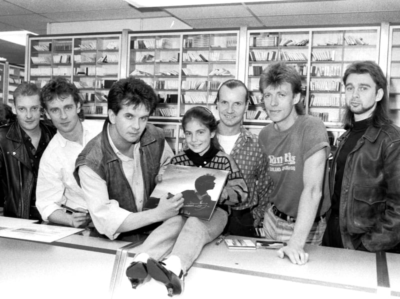 Singer Donnie Munro signs a copy of Scottish rock band Runrig's latest album for Claire Mungavin, aged nine, at John Menzies, Edinburgh, in September 1989