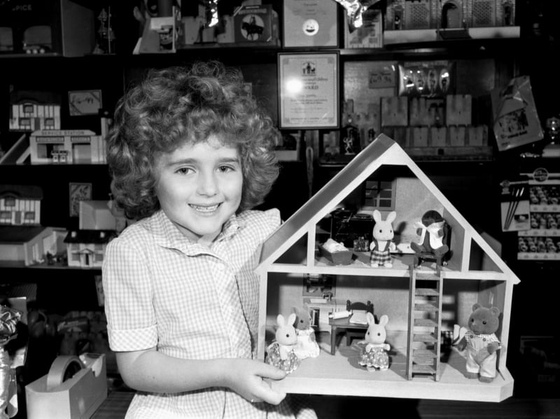 Six-year-old Hazel Paton with a Sylvanian House full of Sylvanian Creatures, one of the more popular toys for younger children in September 1987, at Toys Galore toyshop in Morningside