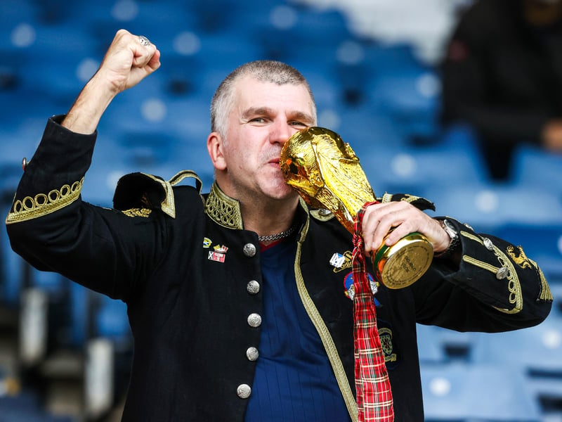 A Scotland Fan with a replica World Cup trophy at Hampden Park.