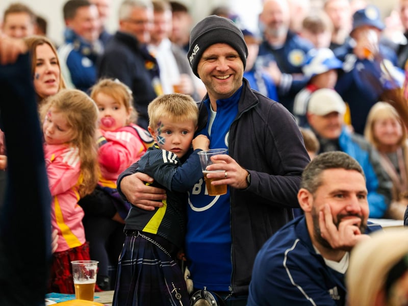 A young fan with his face painted gets ready for the game against Belarus with his family.