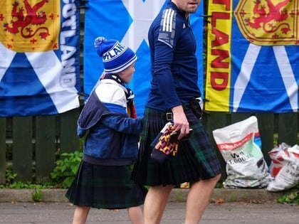Scotland fans wearing kilts make their way to the stadium.