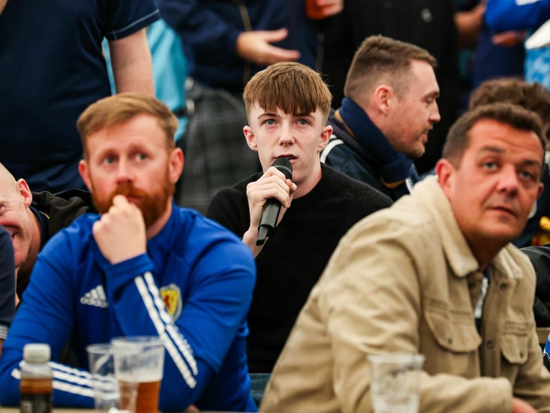 A Scotland fan takes the mic to ask former Scotland international Steven Fletcher a question in the Saltire Square fanzone prior to kick-off.