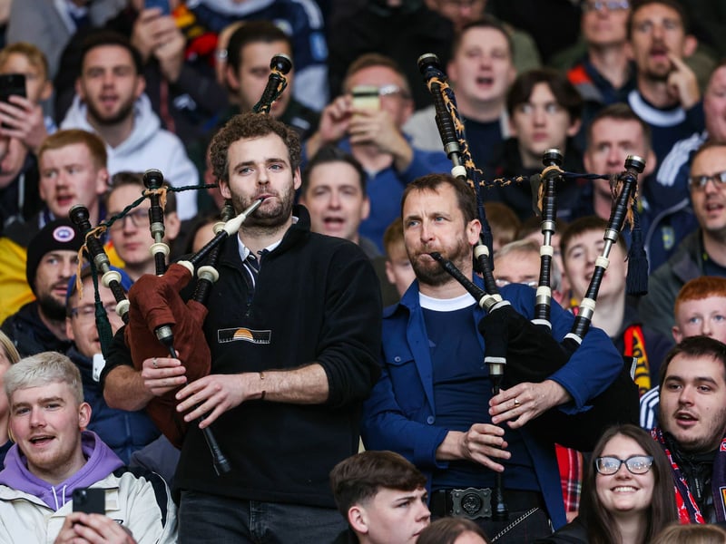 Two Scotland fans play the bagpipes in Mount Florida.