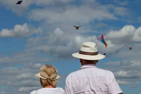 An elderly couple watches as members of the Afghan community and Londoners fly kites on Hampstead Heath. UK pensioners are set for a likely 4.8% state pension rise from April 2026 (Photo: CARLOS JASSO/AFP via Getty Images)