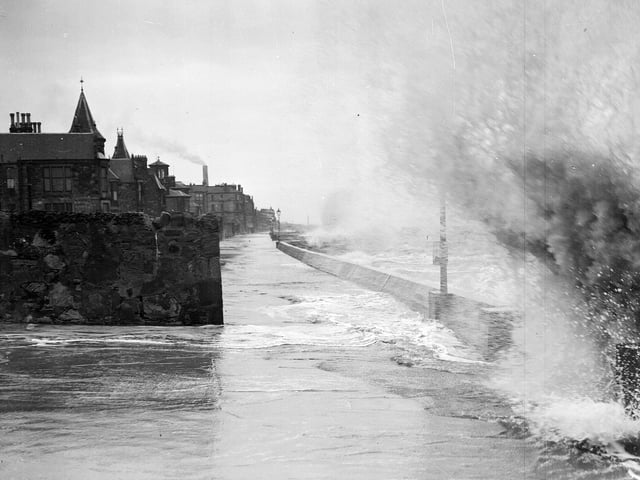 A big wave breaking on a deserted Portobello promenade in 1957.