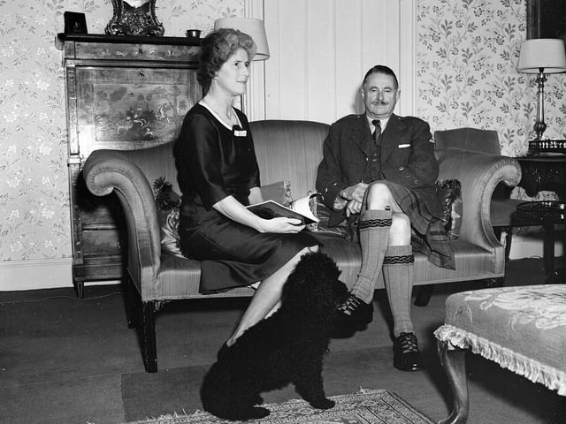 The Earl and Countess Mansfield with their dog at Scone Palace in 1957.