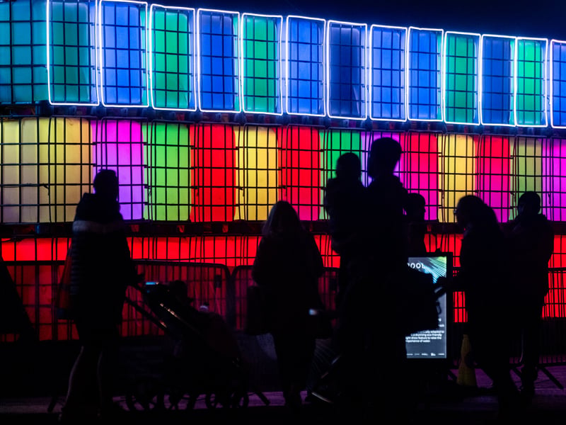 A 16m by 3m creative lighting installation composed of 48 unfilled water containers, which typically hold 1,000 litres of water each, specially adapted to create a stunning eco-friendly lightshow feature to raise the importance of water.