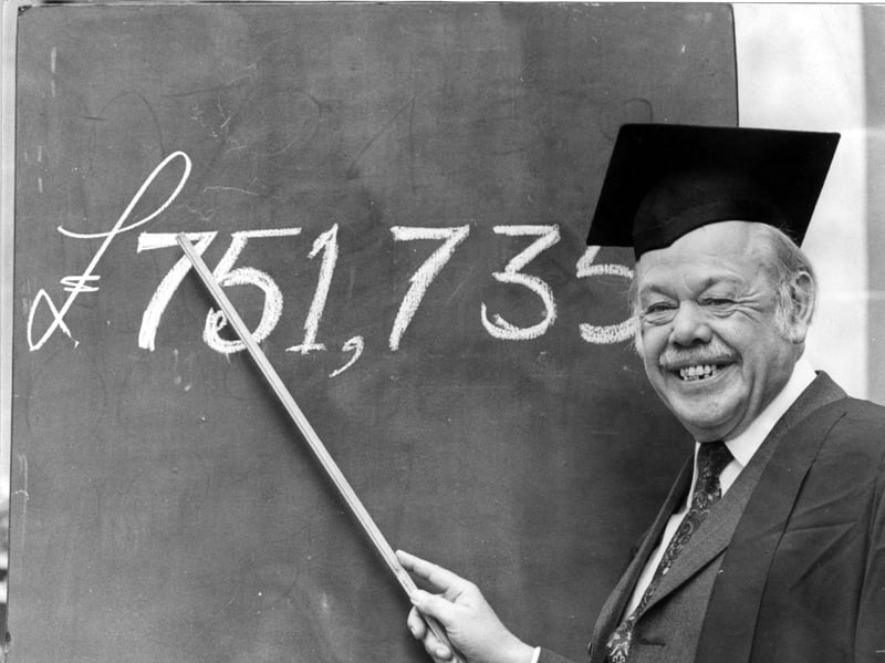 Woodwork teacher Harry Johnson celebrates his Littlewoods Football Pools win of over £750,000 in October 1979. He dons his mortarboard for the last time to point to the exact sum of his winnings on a blackboard.