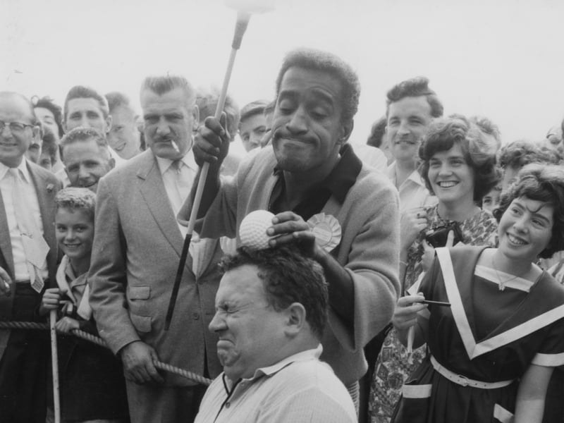 Sammy Davis Jr and Harry Secombe messing around at a Pro-Am Golf event in 1962