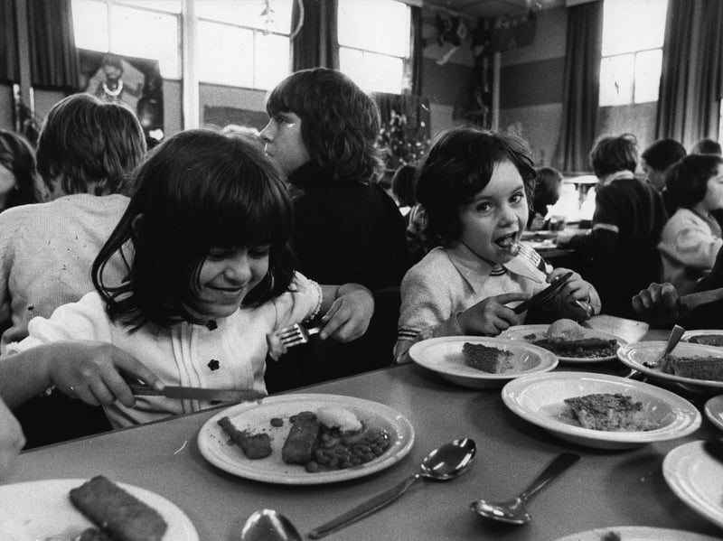 School dinners haven't always had the best reputation, but these pupil are enjoying their meal of fish fingers, baked beans and potato, with sponge and custard to follow, in December 1974